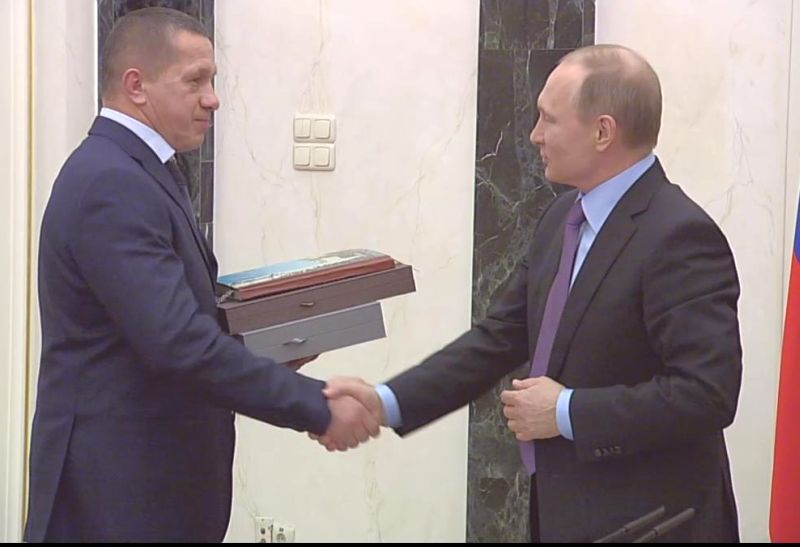 Владимир Путин поздравляет Юрия Трутнева.