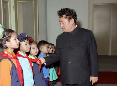 Ким Чен Ир осматривает форменную одежду школьников и детсадовцев. Март 1977 г.