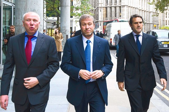 Mr. Abramovich, center, on a break Monday from proceedings in London's commercial court, where he faced the first of several days of questioning. Agence France-Presse/Getty Images